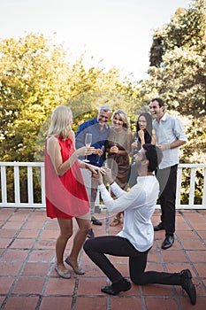 Man proposing woman in balcony