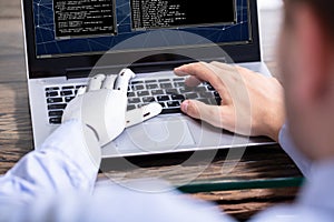 Man With Prosthetic Hand Working On Laptop