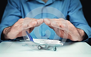 Man protect airplane. Travel insurance concept.