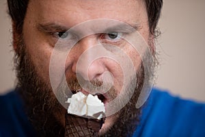 Man protecting his cold ice cream that he is eating