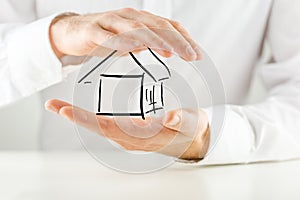 Man protecting a house with his hands