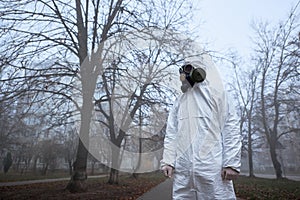 Man in protective clothing outdoors, environmental disaster.