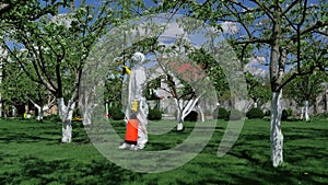 Man in protective clothing working in the yard