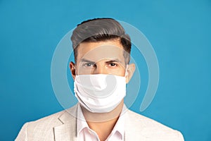 Man in protective face mask on blue background