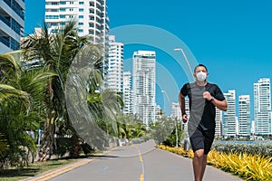 A man with a protective mask running around the city. Fitness, training, sport, lifestyle concept