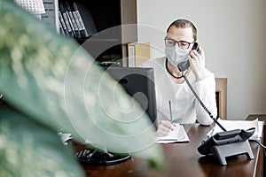 Man in a protective mask talking on phone