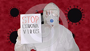 Man in protective suit and facial mask holding in hands clipboard with sign stop coronavirus. Man in protective mask and