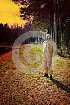 man in protective suit, mask in forest