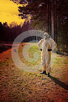 man in protective suit, mask in forest