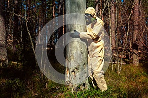 man in protective suit, mask in forest