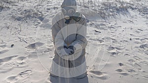 Man in protective suit, mask in sea beach