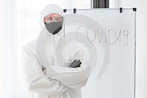 Man in protective suit, medical mask, goggles. Isolated in studio. antigas mask with glasses at white background. Man photo