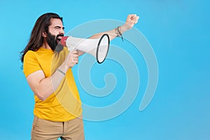 Man protesting while shouting with a loudspeaker