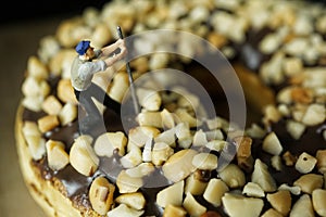 a man is prying nuts on a donut