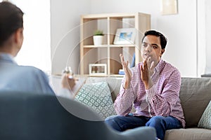 Man and psychologist at psychotherapy session