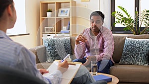 Man and psychologist at psychotherapy session