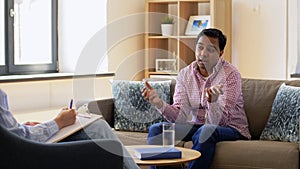 Man and psychologist at psychotherapy session