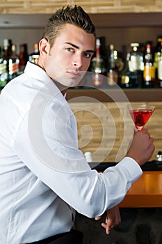 Man in a pub with martini waiting