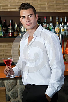 Man in a pub with red martini