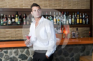 Man in a pub with red martini