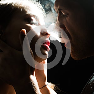 Man puffing smoke into face