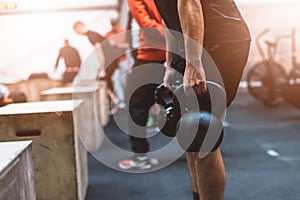 Man pulling kettlebells weights in the functional fitness gym photo