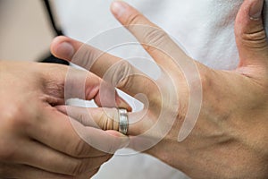 Man pulling ring off finger