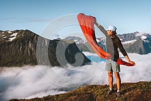 Man pulling sleeping bag out of its cover hiking camping gear active travel vacations in mountains outdoor