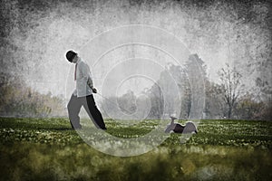 Man pulling toy car in field