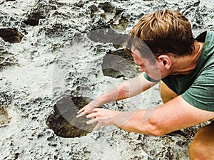 Man pulls his hands into mystic dark moon crater. Astrology, astronomy, paranormal activity concept or scary