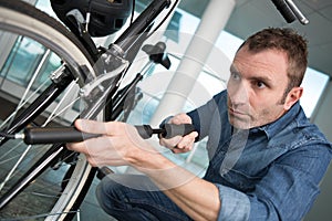 man pumping bicycle tire close-up on hands