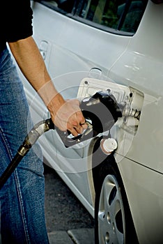 Man pumping gas into car photo