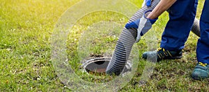 Man pumping out house septic tank. drain and sewage cleaning service. copy space