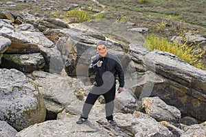 Man in a pumpkin mask in the mountains.