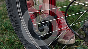 A man pumps a Bicycle wheel. breakage on the road