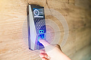 Man push finger down on the electronic control machine to access the door