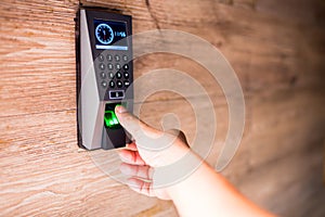 Man push finger down on the electronic control machine to access the door