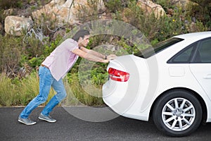 Man pushing car after a car breakdown