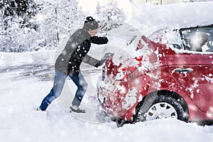 Man Pushing A Car Stuck In The Snow