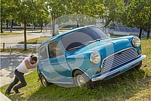 Man pushing his car