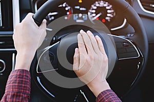 Man pushing horn while driving sitting of a steering wheel press car,