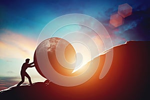 Man pushing huge concrete ball up hill