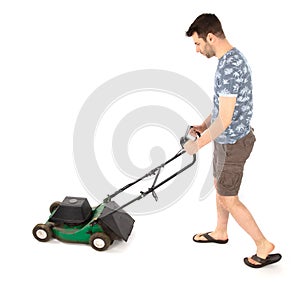 Man pushing old green lawn mower