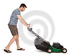 Man pushing old green lawn mower