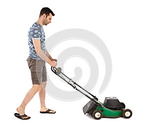 Man pushing old green lawn mower