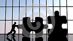 A man pushing a piece of puzzle to assemble two pieces.