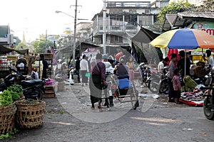 Man pushing a rickshaw with woman