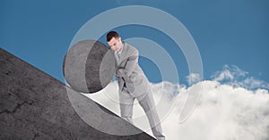 Man pushing rolling round rock