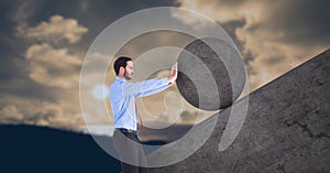 Man pushing rolling round rock