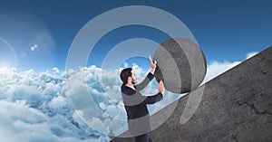 Man pushing rolling round rock